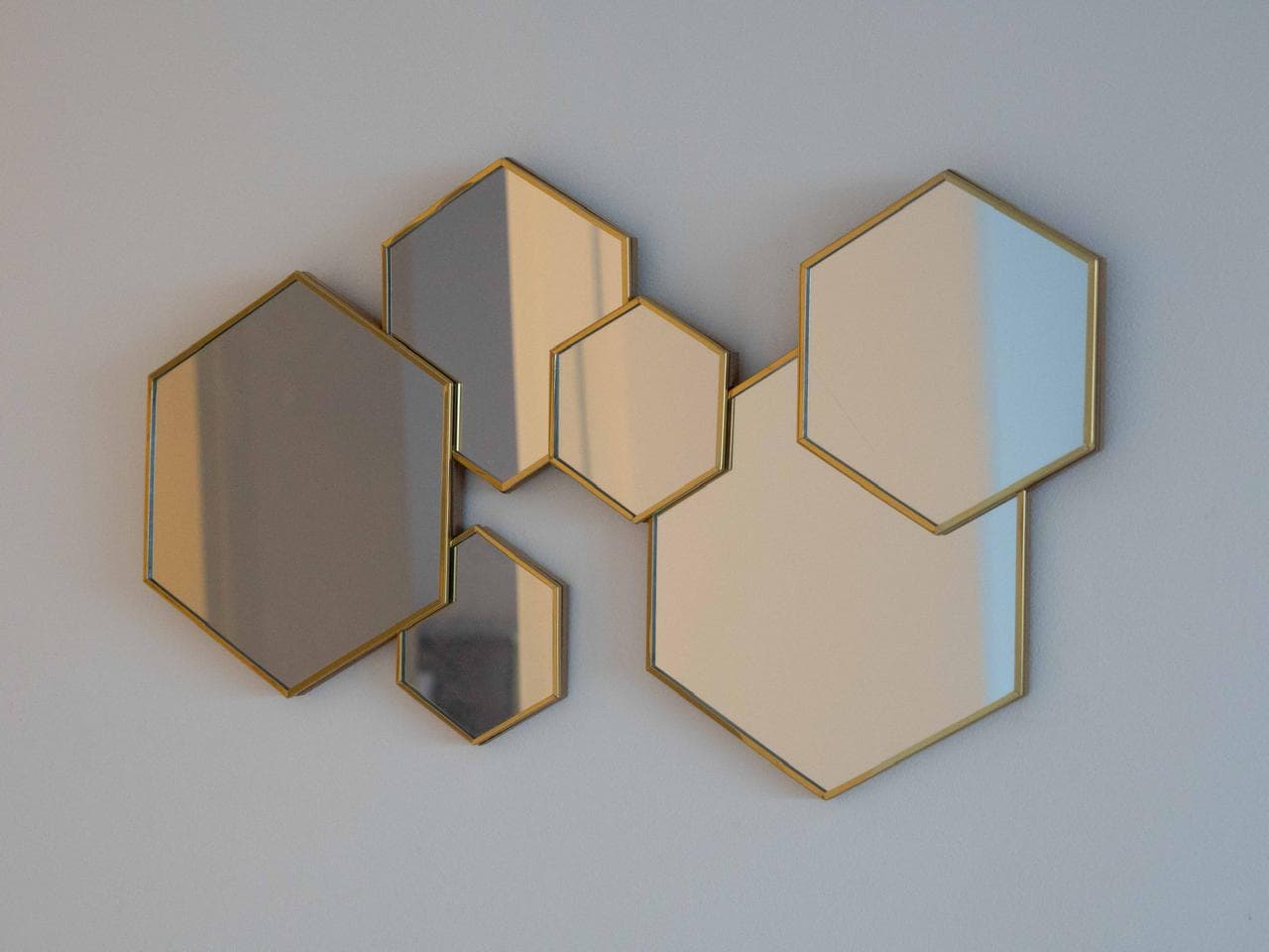 Gold hexagonal mirror detail in the villa's interior