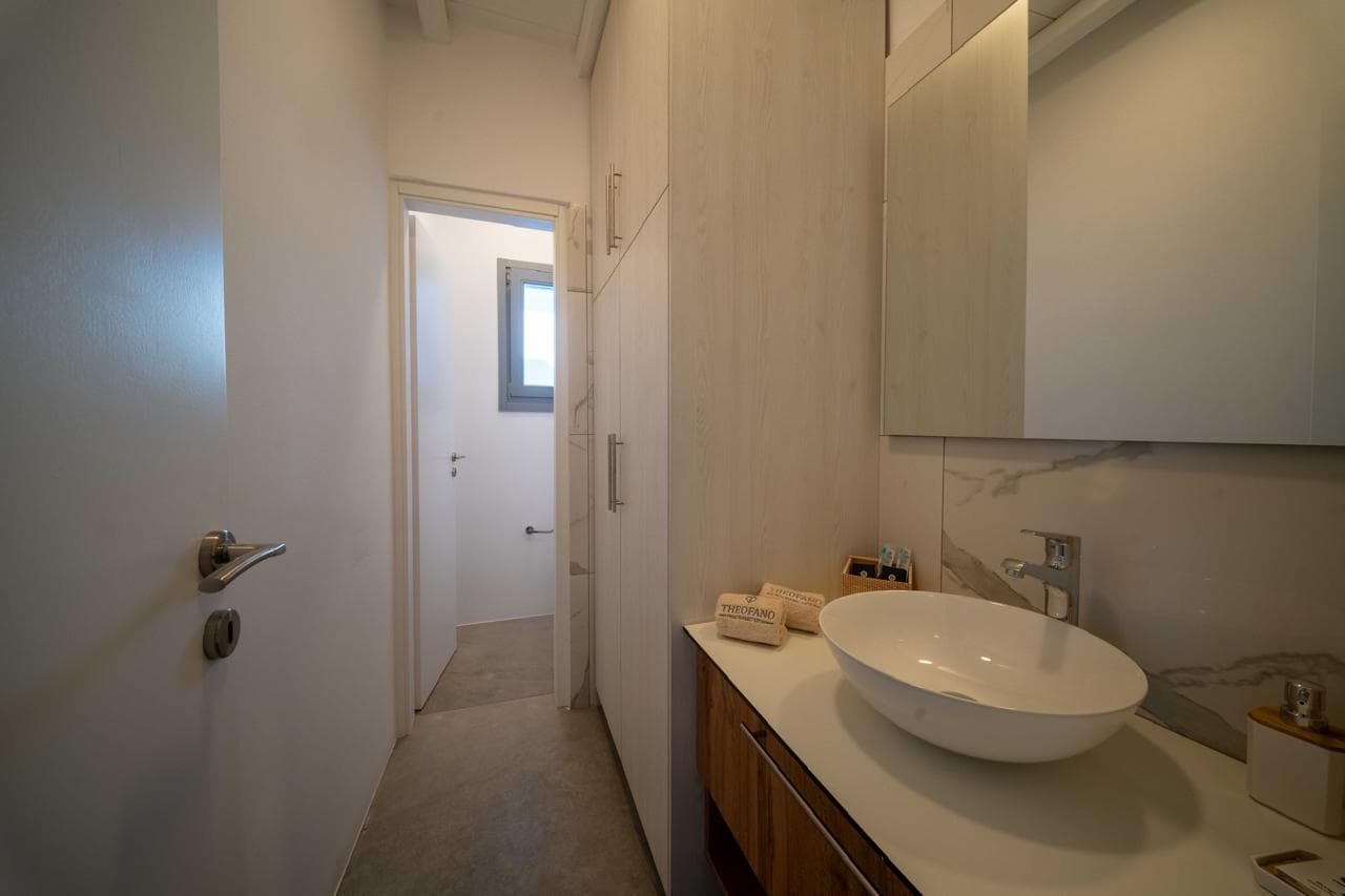 Bathroom vanity and corridor in soft neutrals