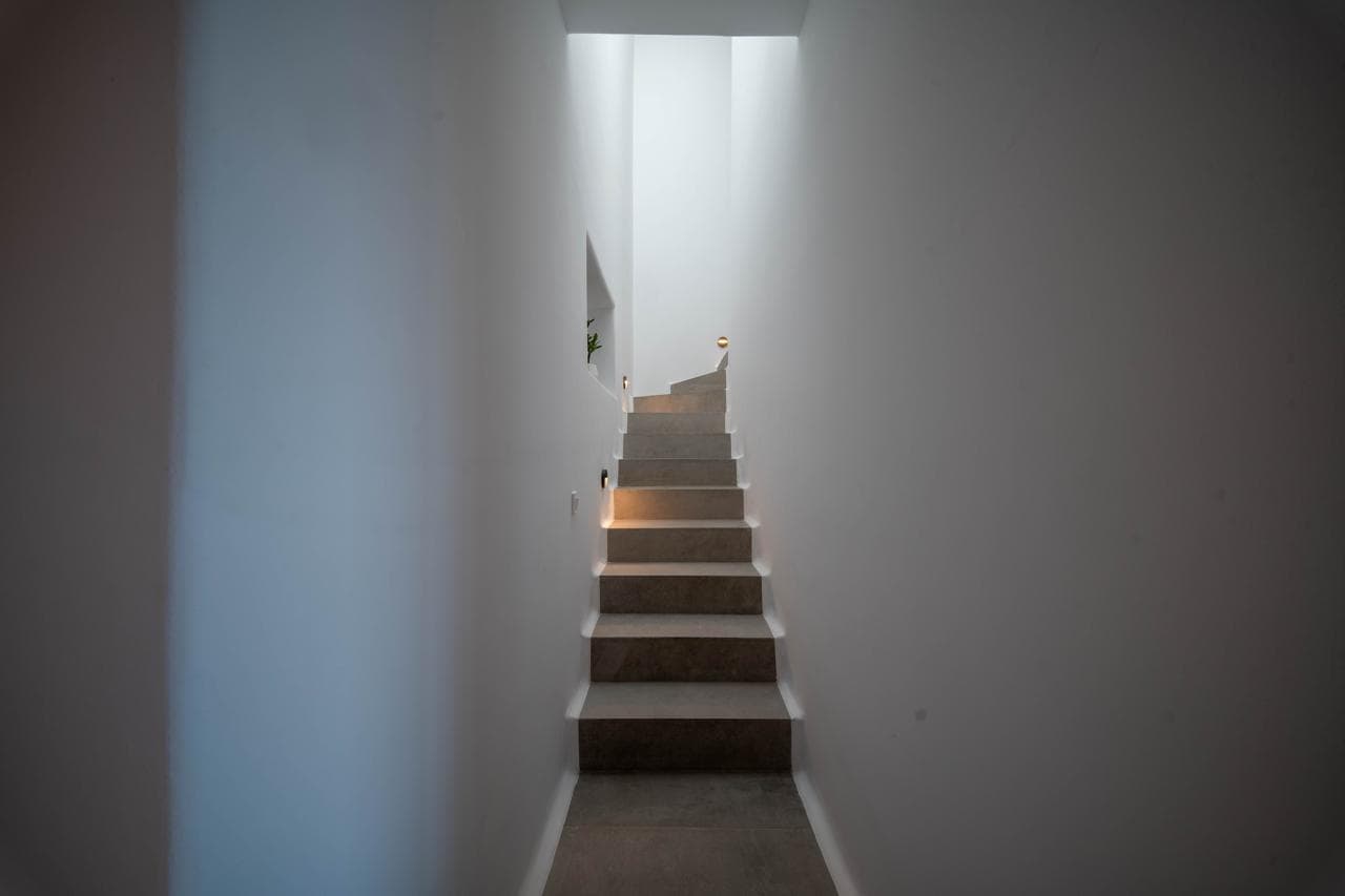 Whitewashed staircase with soft lighting