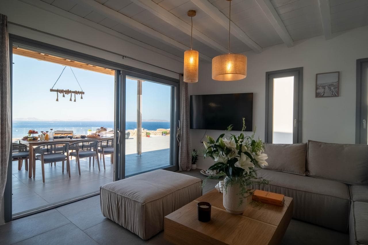 Open-plan living room flowing onto the panoramic terrace