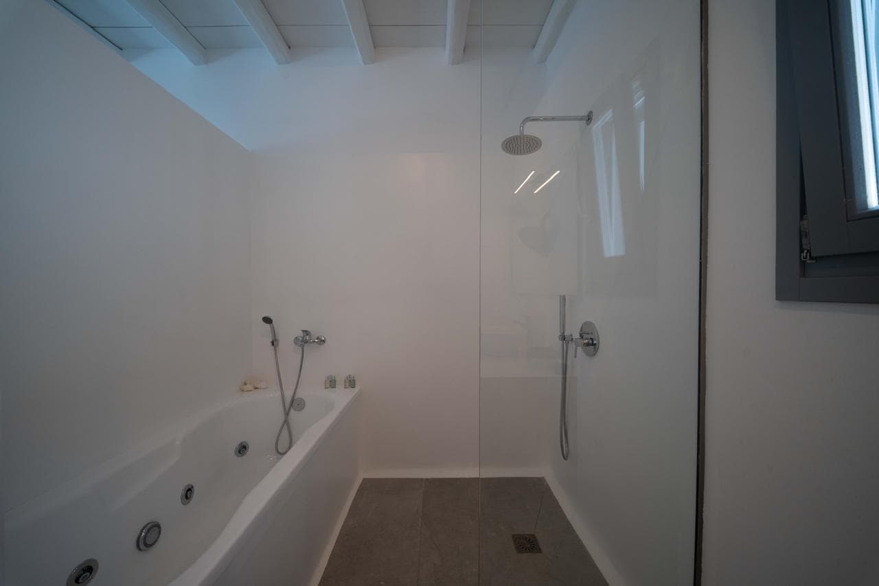 Bathroom with whirlpool bathtub and walk-in shower