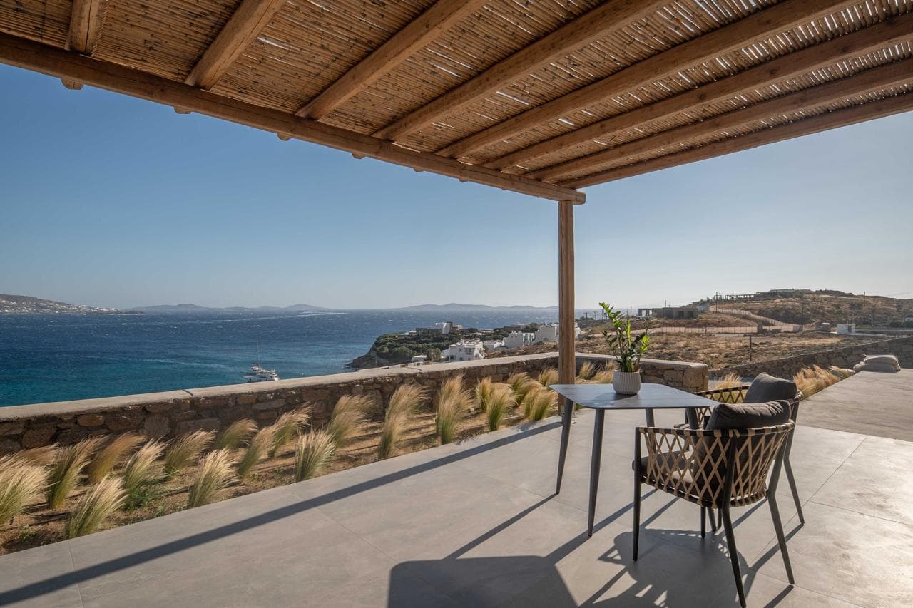 Covered terrace with bistro table above the coastline