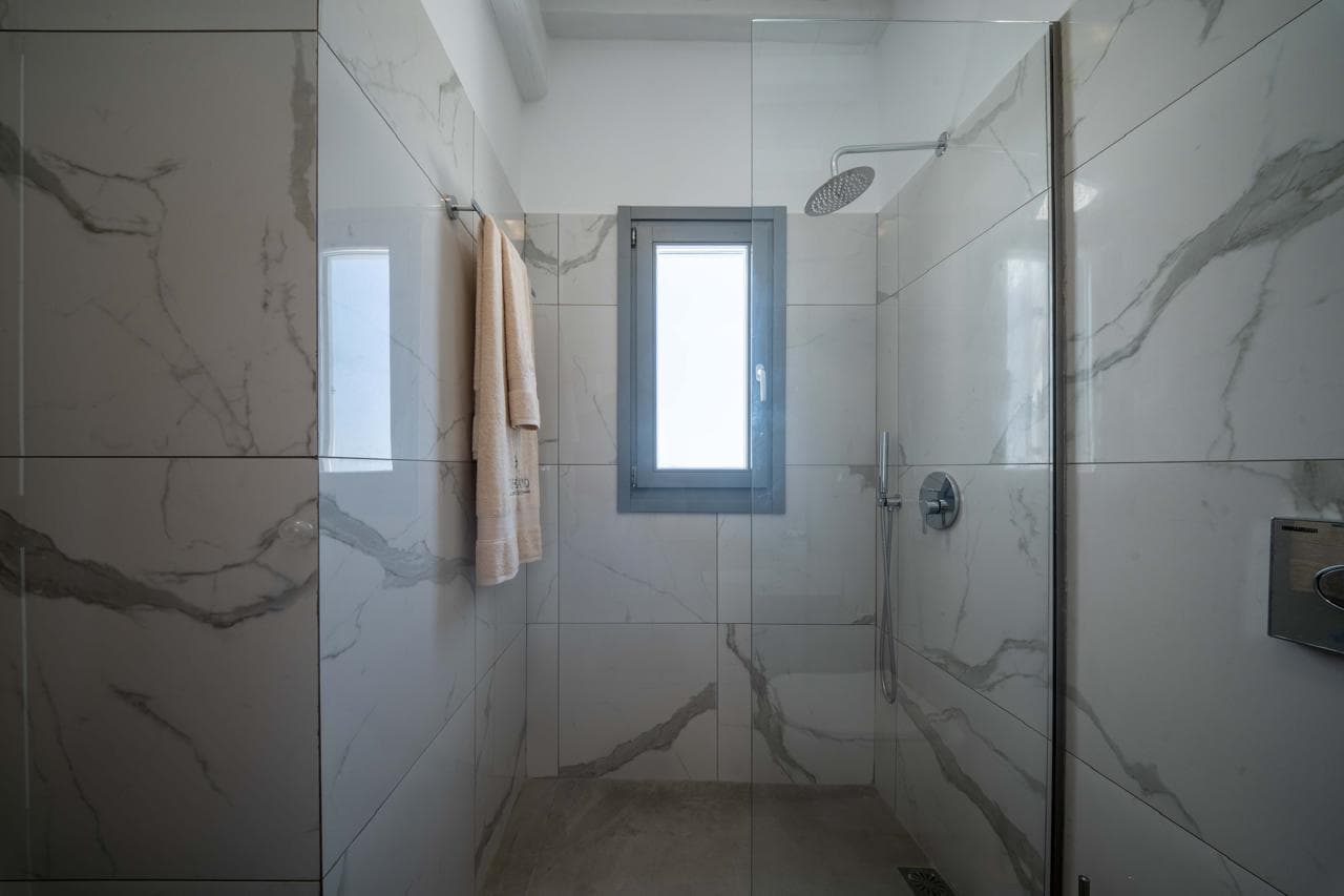 Marble walk-in shower with sea-light window