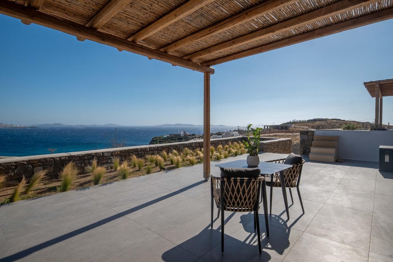 Panoramic terrace with lounge seating above the sea