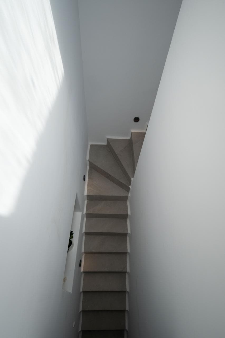 Sculptural whitewashed staircase