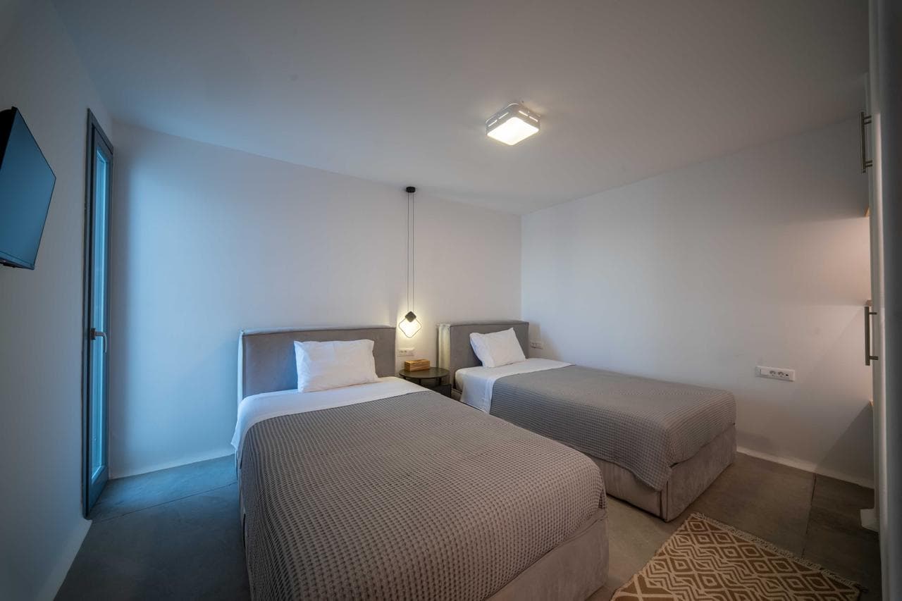 Twin guest house bedroom in cool tones