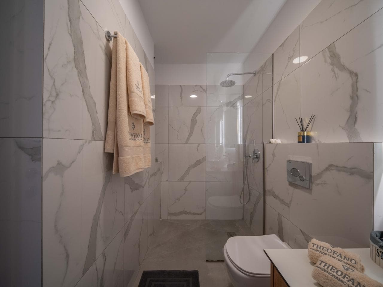 Marble shower room with branded towels