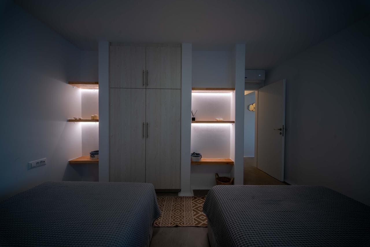 Twin bedroom with illuminated wardrobes